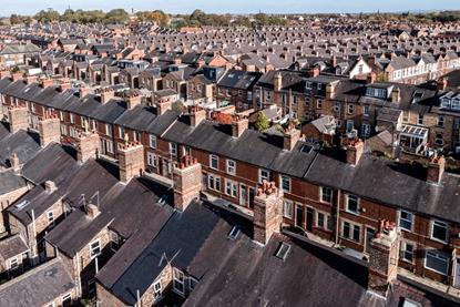 Aerial view of old terraced houses on back to back streets in the suburbs of a large UK city in the North of England