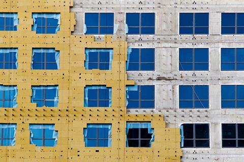 A building being covered in stone wool insulation